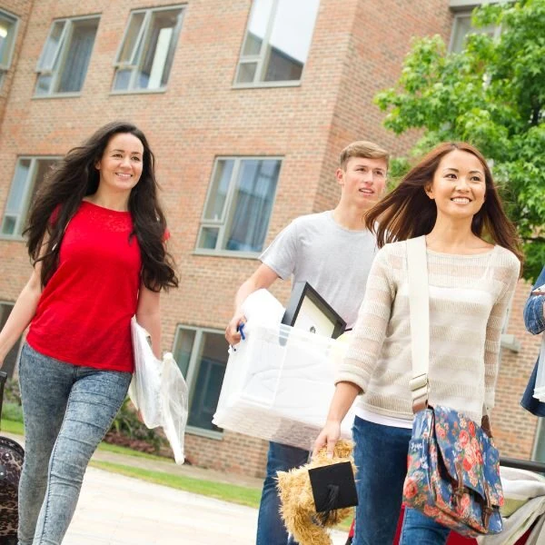 Four international students in France carry items to StoragePal for storage